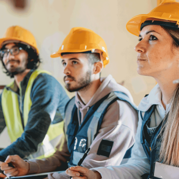 Three people are listening to their foreman on a construction-Image credit-iStock-1465962688