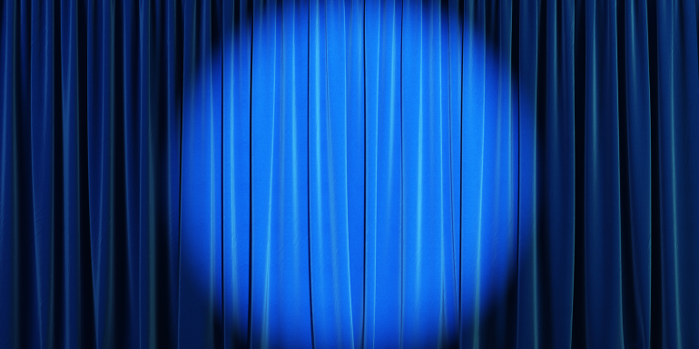 web_blue-curtain-with-spotlight_credit_istock-1223199962.png