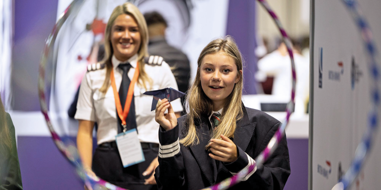 Students learn and have fun at the annual Big Bang Fair pilot watches as student attempts to fly paper plane through obstacle course