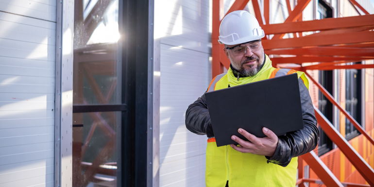 cheerful architect with a yellow reflective vest.istock-1481727247