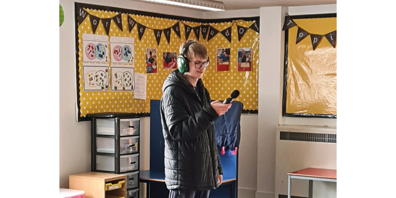 sonny taking sound level readings in a classroom CREDIT- Supplied