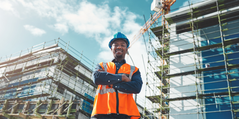Engineer, construction and portrait of a black man at building site for development and architecture. CREDIT_shutterstock_2302260709