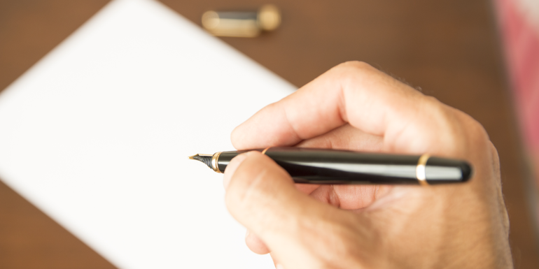 hand and pen . CREDIT - shutterstock-334056554