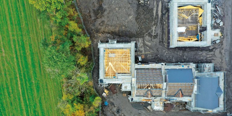 House development construction site in progress aerial view UK - CREDIT- istock- 1306324733