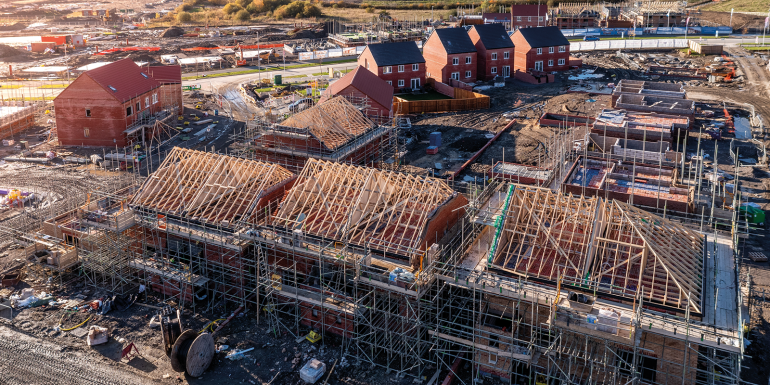 Aerial view of a construction site with new build. CREDIT - Shutterstock - 2384416179
