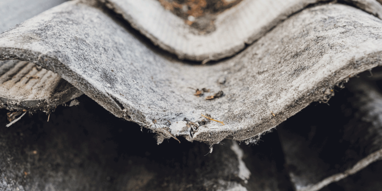 Old and very dangerous asbestos roof. Asbestos dust in the environment. Health problems. Image credit-iStock-1663765377