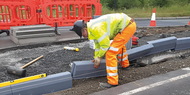 Construction worker installing road curb blocks.CREDIT_Phil-Sutton_Founder-of-Duraproducts
