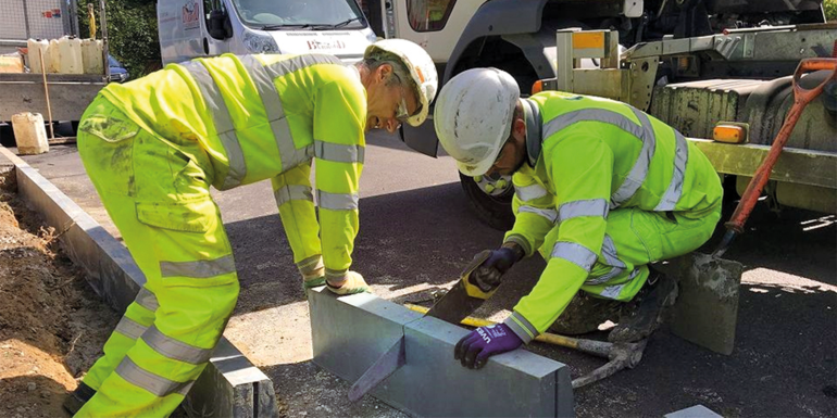 Construction worker installing road curb blocks.Image credits | Phil Sutton Founder of Duraproducts
