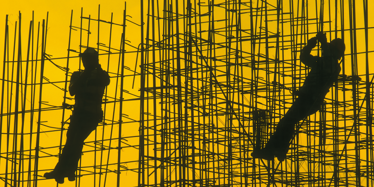 Silhouettes of workers on steel framework.istock-179132861
