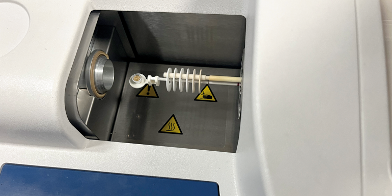 Wood powder sample filled in aluminum crucible to be tested in thermogravimetric analysis