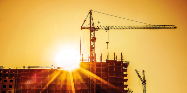 construction site building crane sunset. CREDIT_shutterstock_1368636473
