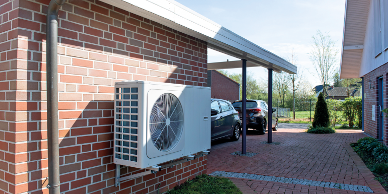 Air source heat pump on house exterior.Image credit | istock-2150881312
