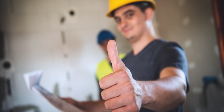 construction worker giving thumbs up in the interior of newly constructed_CREDIT_istock-1164272119