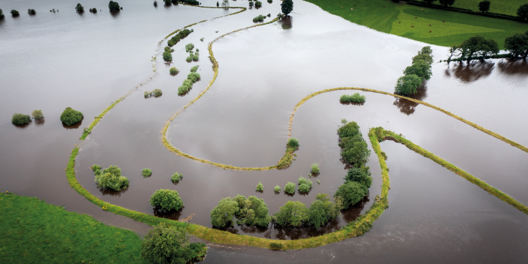 River in Flood Omagh Northern Ireland- Fairy Water.CREDIT_shutterstock_2379871931