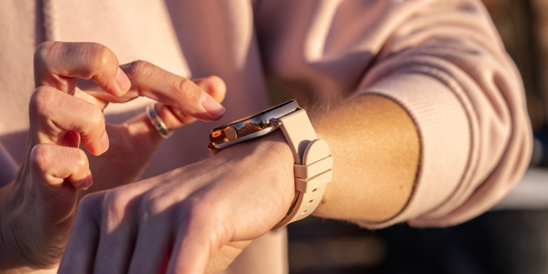 Woman hands in smart watch walking outdoors, step counting, fitness tracker, close up, copy space.Image credit | Shutterstock