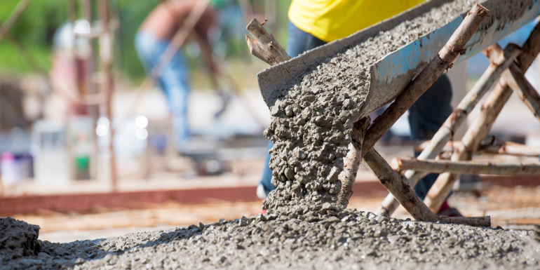 Close up ready mix concrete at construction site.CREDIT_Bannafarsai_shutterstock_2307050647