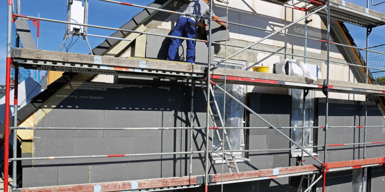 Construction workers insulating house facade.Image credit | shutterstock- 1184665054