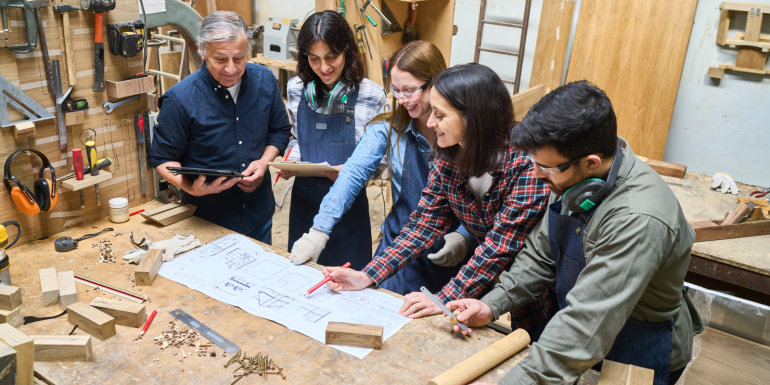 diverse group young apprentices collaborates experienced.Credit_Robert-Kneschke_shutterstock_2559760201