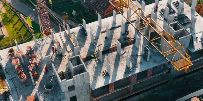 highrise construction site crane workers aerial. Credit_Ira.foto.2024_shutterstock_2544250439