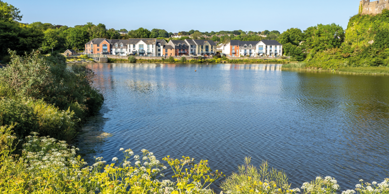 Colorful houses in Pembroke town besides Pembroke castle. Image credit | iStock