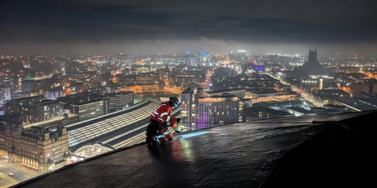 shows engineers working on top of St Johns Beacon.