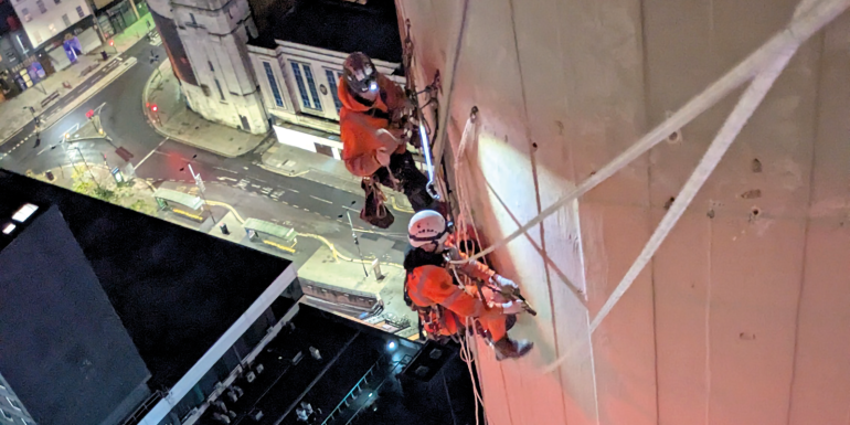 shows engineers working on top of St Johns Beacon