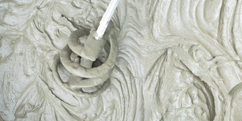 Concrete mixing with electrical drill and mixer, defocused blurred view. CREDIT_shutterstock_2027639477