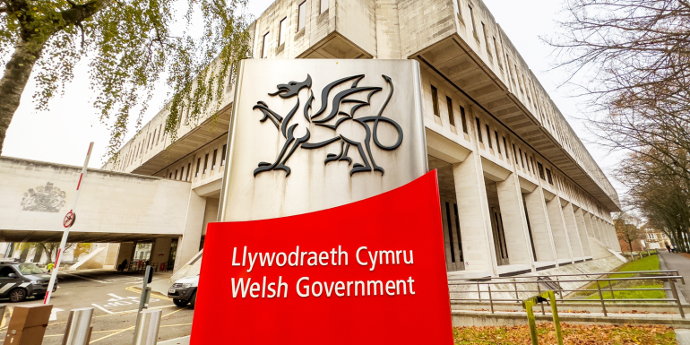 Cardiff, Wales - November 2022: Sign outside the entrance to the Welsh Government's main offices in Cathays Park near the city centre.CREDIT_shutterstock_2234065451