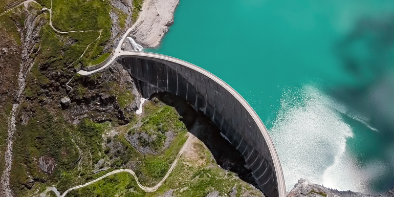 Overhead aerial view of Stausee Mooserboden Dam, Kaprun, Austria . CREDIT_iStock-1248957846