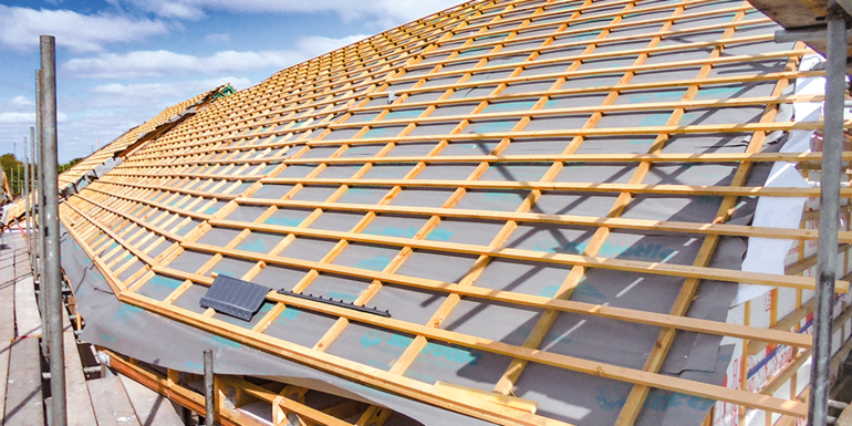 Wooden roof framework under construction.