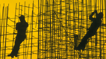 Silhouettes of workers on steel framework.istock-179132861