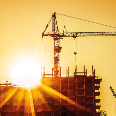 construction site building crane sunset. CREDIT_shutterstock_1368636473