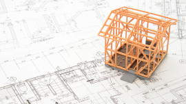 web_model-house-on-blueprints_credit_istock-468098262.png