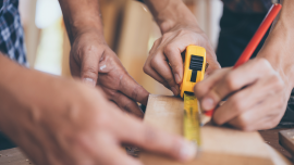 Craftsman carpenter team cooperating on building construction planning