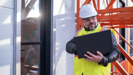 cheerful architect with a yellow reflective vest.istock-1481727247