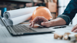 hand laptop blueprints.CREDIT-istock-1431874851