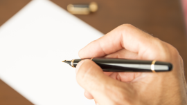 hand and pen . CREDIT - shutterstock-334056554