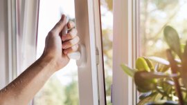 hand open white plastic pvc window at home CREDIT - istock - 830679624