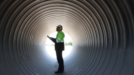 Chief engineer with green reflective safety jacket check project progression. CREDIT - Istock-1883020560