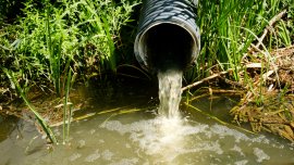 sewage pipe discharges sewage and wastewater into the river environmental pollution. Image credit | iStock-1419861669
