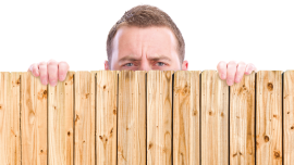 man looking over fence. CREDIT_istock-155159978