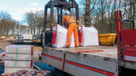 ropside flatbed HIAB crane lorry with brick grab attachment deliver materials on construction site and offloading them.Image credit | istock-2042763702