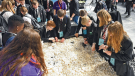 Students building with white LEGO bricks.Image credits | Alamy