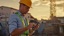 web_male-construction-worker-checking-smartphone-at-site-during-golden-hour_credit_simonskafar_istock-2208108898_1600x800.jpg
