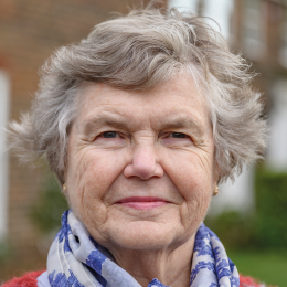 Outdoor headshot of senior woman in sweater and scarf . istock-1288921154