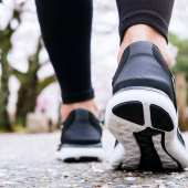 Woman Legs Sport Shoe Walk In Park Outdoo.iStock-961726470