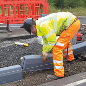 Construction worker installing road curb blocks.CREDIT_Phil-Sutton_Founder-of-Duraproducts