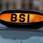 Orange taxi sign with "BSI" letters