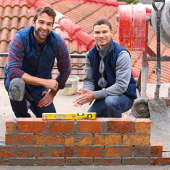 construction bricklayer men building brick wall. CREDIT_shutterstock_2440987653