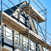 house with scaffolding. CREDIT_iStock-1305219914